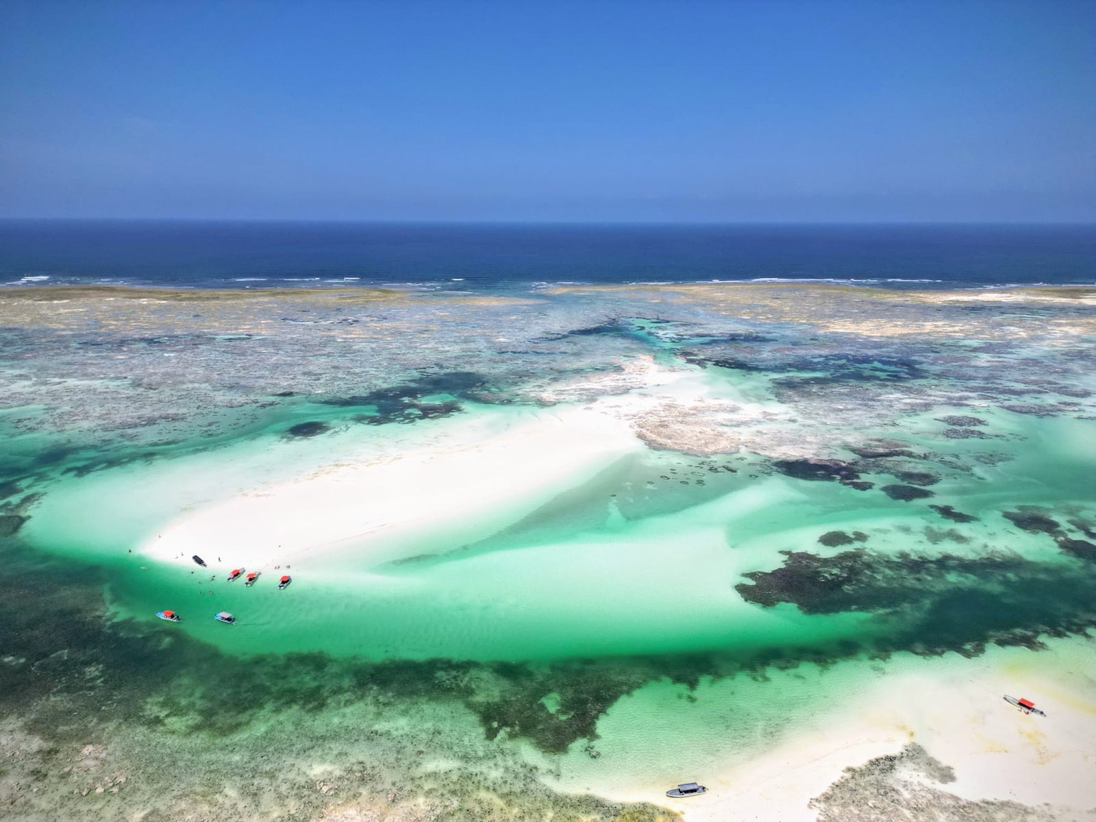 Mchanga sandbank surrounded by turquoise water, aerial