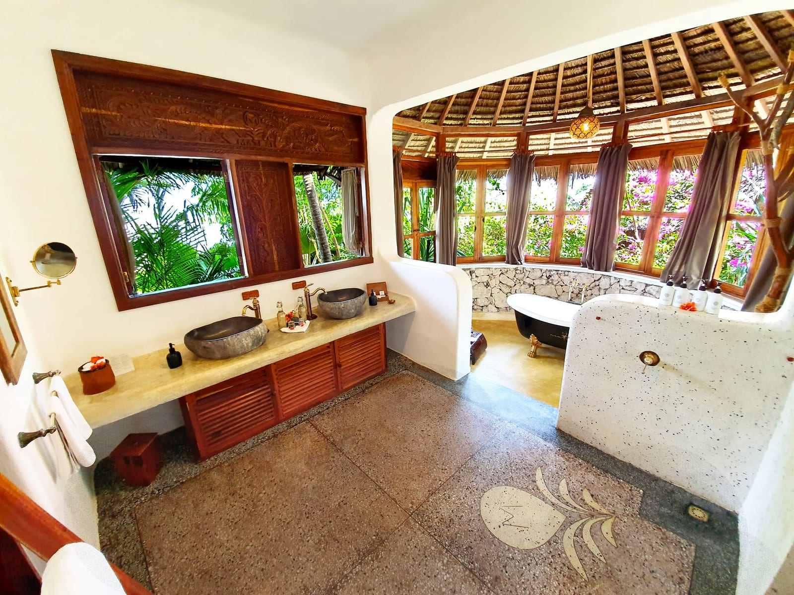 Bathroom detail at Asili House, in stone and dark wood