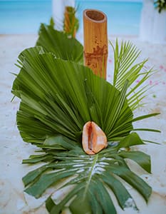 tropical wedding decoration detail in Zanzibar with palm leaves and natural styling