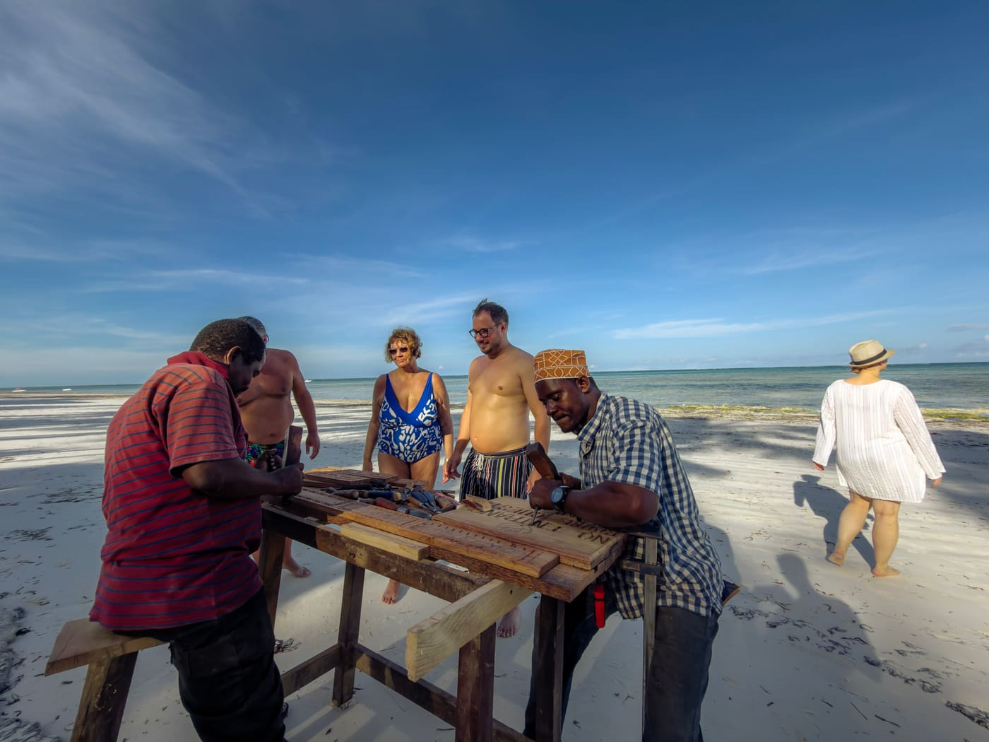 Local men at the beach carving souvenirs