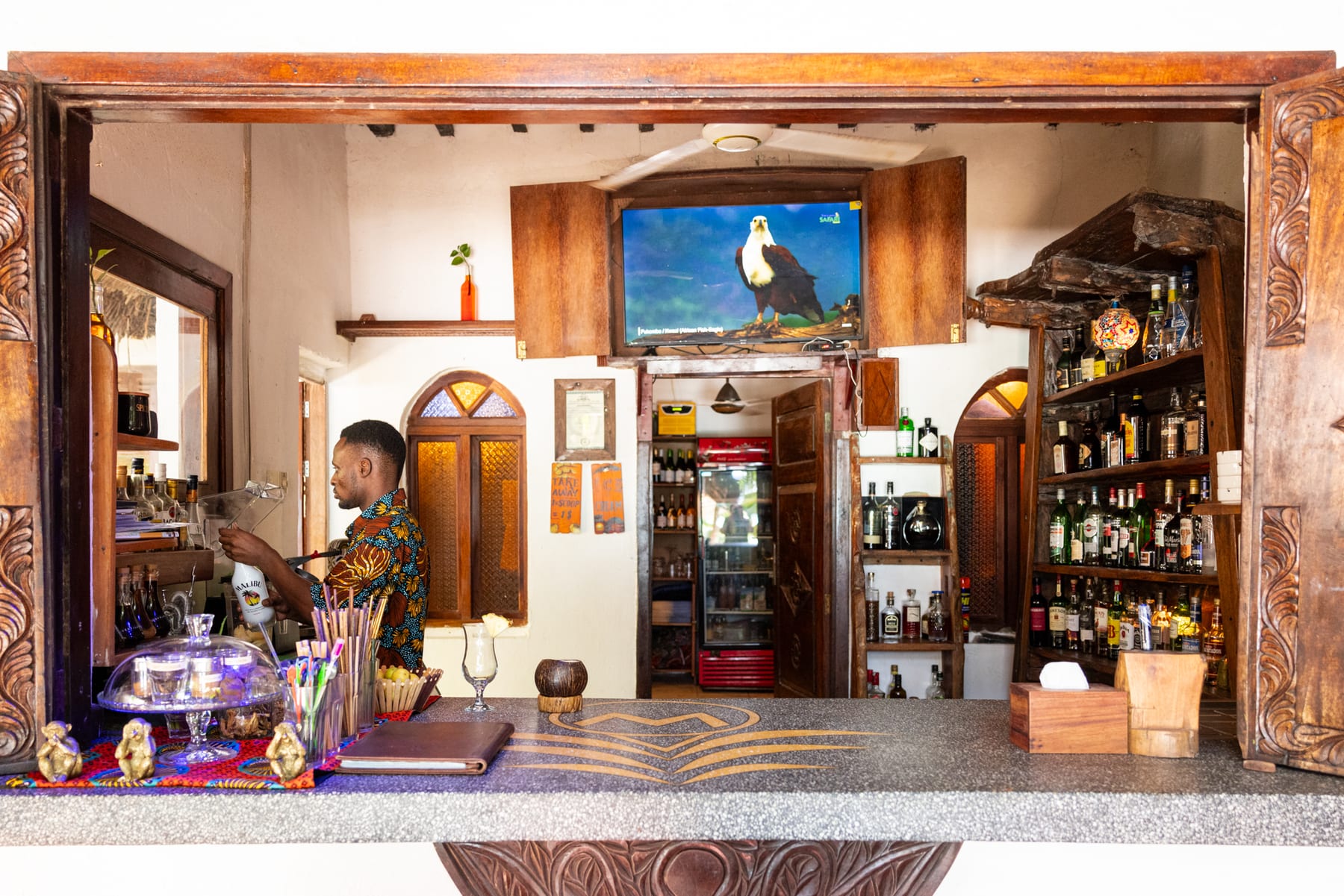 Bar interior at Zatiny Restaurant, Boutique Hotel Matlai Zanzibar, showcasing a wide rum selection.