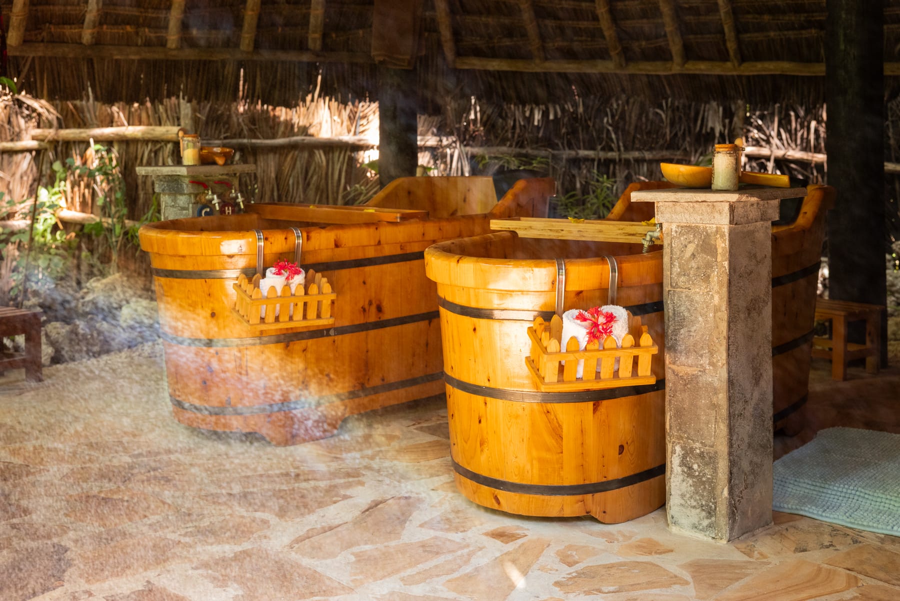 Two wooden tubs at Bustani, steaming, drawn for a herbal bath.